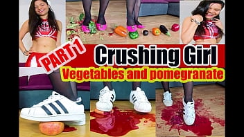 Girl crush different things, like a pomegranate, a normal apple, avocado, aubergine, red, green and yellow peppers, Easter eggs and strawberries are also crushed