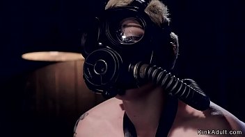 Strapped and set to ride wooden horse blonde slave Elizabeth Thorn in gas mask gets hard whipped then in doggy style device tormented with water