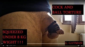 Cock and balls tied together, squeezed by 8 kg weight